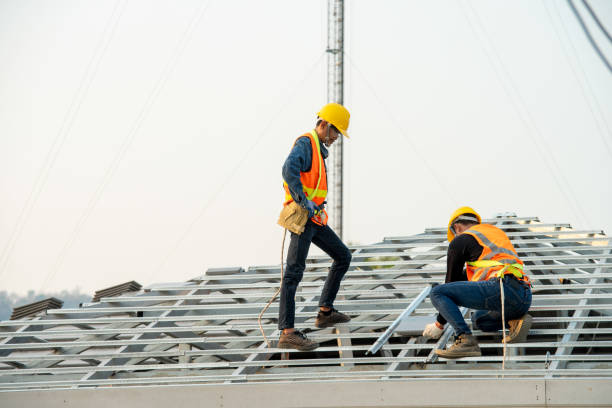 Two roofers inspecting new roof,Professional Roofer Worker Finishing Ceramic Roof Tiles Installation.