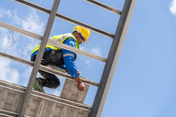 Construction worker installing new roof under construction residential building. roofing and sky with copy space.